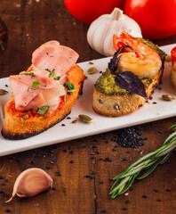 Delicious italian appetizer bruschetta presenting variety of toppings
