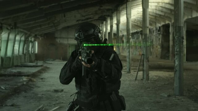 Quick reaction force operator in black military outfit and an m4 assault rifle with a green laser running in an abandoned warehouse