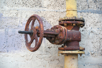 Rusty valve on a pipe gate.