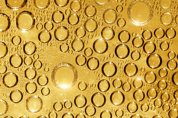 Golden water rops on blue background.