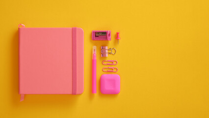 Closed pink notebook with felt-tip pen, sharpener, paper clips and eraser. Space for your text.