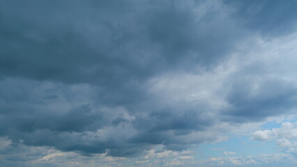 Fototapeta premium Cumulus clouds moves in the blue sky. Extreme weather before rain. Time lapse.