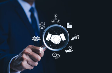 Business partnership and collaboration concept. Businessman highlights a handshake icon...
