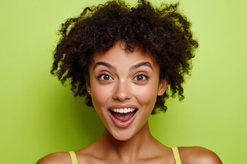 Joyful Woman with Curly Hair Against Green Background