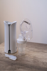 The nebulizer for inhalation is on the table. Treatment of colds and coughs during the disease...