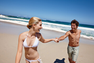 Laugh, beach and happy couple holding hands on holiday, summer vacation or travel. Love, man and woman at ocean for support, romantic connection or excited for healthy relationship and walk on date