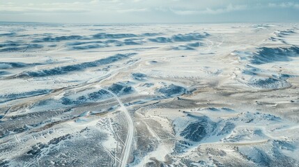 Aerial View of Snow-Covered Hills and Roads in Winter