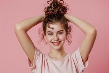 Fototapeta premium A young girl with curly hair smiles happily, making her a great subject for any image about childhood innocence and joy