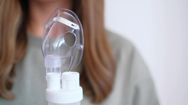 The inhaler, nebulizer, the girl is preparing for a home procedure, treatment of colds in the season of illnesses