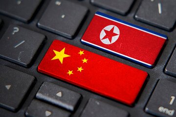 China and North Korea flags on computer keyboard
