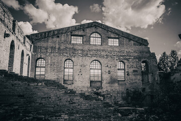 Ruins of an old abandoned factory building. Black and white photo.