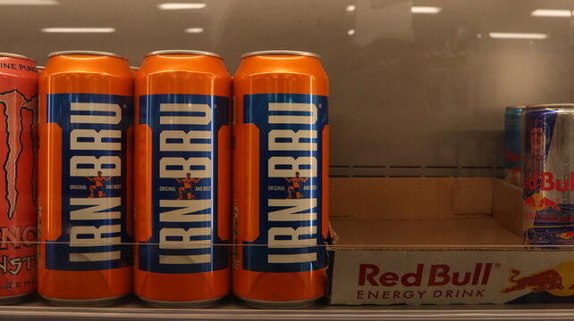 PONTYPRIDD, MID GLAMORGAN, WALES, UK - SEPTEMBER 25, 2024: IRN BRU BOTTLES SCOTTISH SOFT DRINK ON DISPLAY