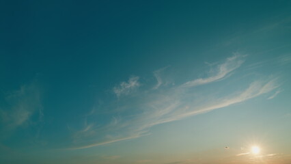 Delicate cirrus clouds in sky in september. Natural background texture taken on sunny day.
