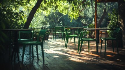 A serene outdoor caf&eacute; setting with green chairs and wooden flooring under dappled sunlight.