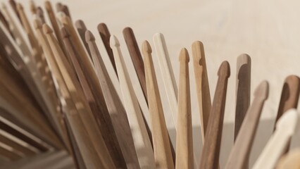 3d rendering of multiple wooden drumsticks with focused tips and blurred handles in the background