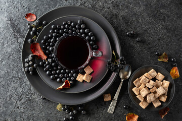 Black chokeberry juice, fresh berries, and pieces of brown sugar.