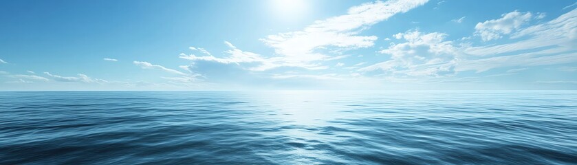 Obraz premium Sunny day with blue sky and calm ocean water.