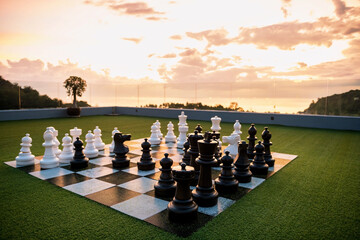 black and white chess game with andaman sea at sunset, Phuket