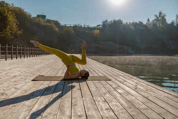 Engaging in a Serene Yoga Practice by the Water at Sunrise to Promote Inner Peace and Balance