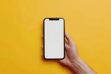 Female hand holding smartphone with blank screen on yellow background, mockup