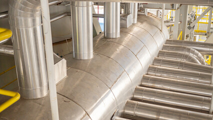 Industrial Piping System. Close-up view of an industrial piping system with multiple pipes and...
