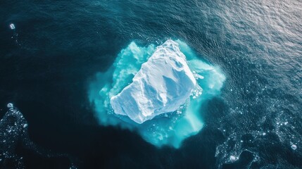 Fototapeta premium A drone shot capturing the intricate patterns of an iceberg's surface as it floats in icy waters.