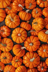 A collection of small orange pumpkins on a table, perfect for fall or harvest themed images