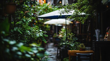 A tranquil alleyway cafe surrounded by lush greenery and outdoor seating.