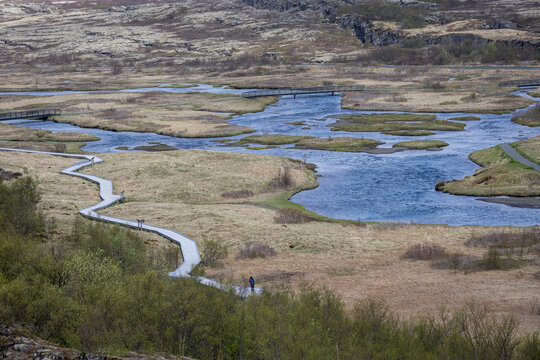 winding river and wooden path in Thingvellir (&THORN;ingvellir) National Park, Iceland