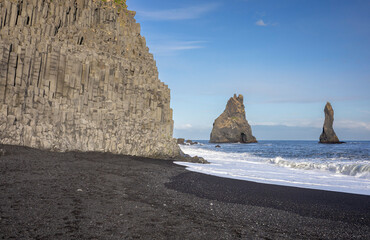 basalt columns and the Reynisdrangar sea stacks from the black sand beach of Reynisfjara, Vík, South Iceland