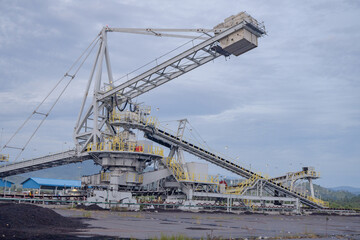 Industrial Conveyor Belt System. A large industrial conveyor belt system with a crane in a mining facility.