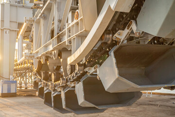 Close-up of Industrial Conveyor System. A close-up view of a large industrial conveyor system with its complex network of chains, belts, and metal structures.