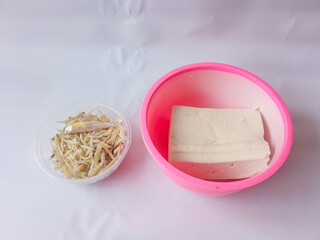 two bowls of tofu and anchovies isolated on white