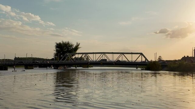 Sunset over a bridge during floods on the river R&aacute;ba in Győr Hungary