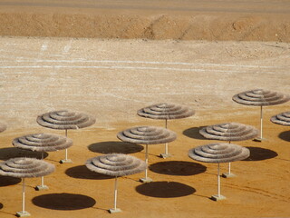 Sun Umbrellas on the beach of the Dead sea
