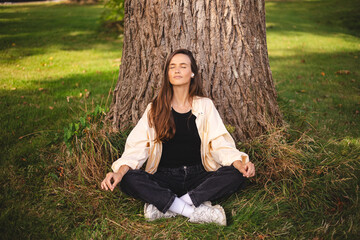 Young nice looking woman with brunette hair listening to the music, mantra, audio book or podcast...