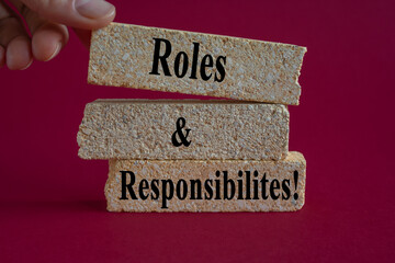 Roles and Responsibilities symbol. Concept words Roles and Responsibilities on brick blocks on a...