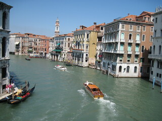 grand canal city. Romantic Venetian landscape. Tourists in a gondola on a walk along a Grand Canal in the old town. Famous historical heritage city.