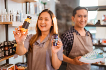 blurred picture of staff holding paint product for shoes