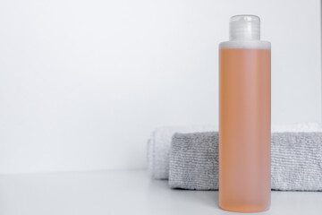 Sleek bathroom essentials with shampoo and body lotion on soft towels in a tranquil setting