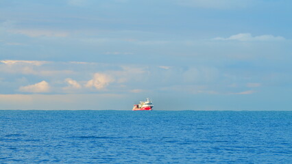 Fishing Boat Fishing In The Sea With Sky And Clouds. Small Boat Float. Static View.