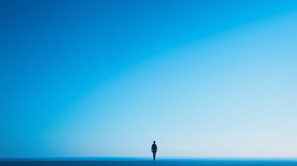 A silhouette of a person on the horizon against a bright blue sky, evoking a sense of vastness and solitude. The horizon and sky blend into a harmonious color gradient