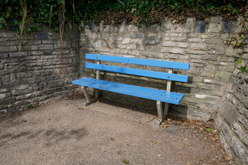 A blue bench in public park. empty seat 