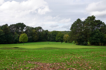 View over parkland golf course on autumn day. sporting lifestyle. Golf hole green and fairway