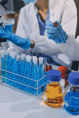 Scientist using microscope in laboratory. Close-up of a researcher's hands adjusting a modern microscope in a lab setting. Science concept