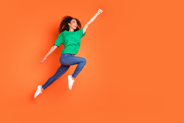 Photo of young funky sportive girl jumper having ambitions raised fist up overjoyed winner isolated...
