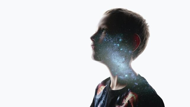 Isolated combination of the silhouette of a child face and the stars of the Milky Way. Concept of the connection between man and the universe, new discoveries and space exploration