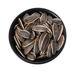 Sunflower seeds in bowl isolated on white, top view