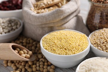 Different types of legumes and cereals on white table, closeup