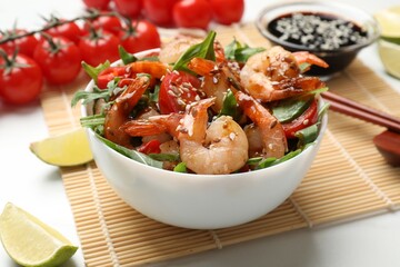 Delicious shrimp salad in bowl served on white table, closeup